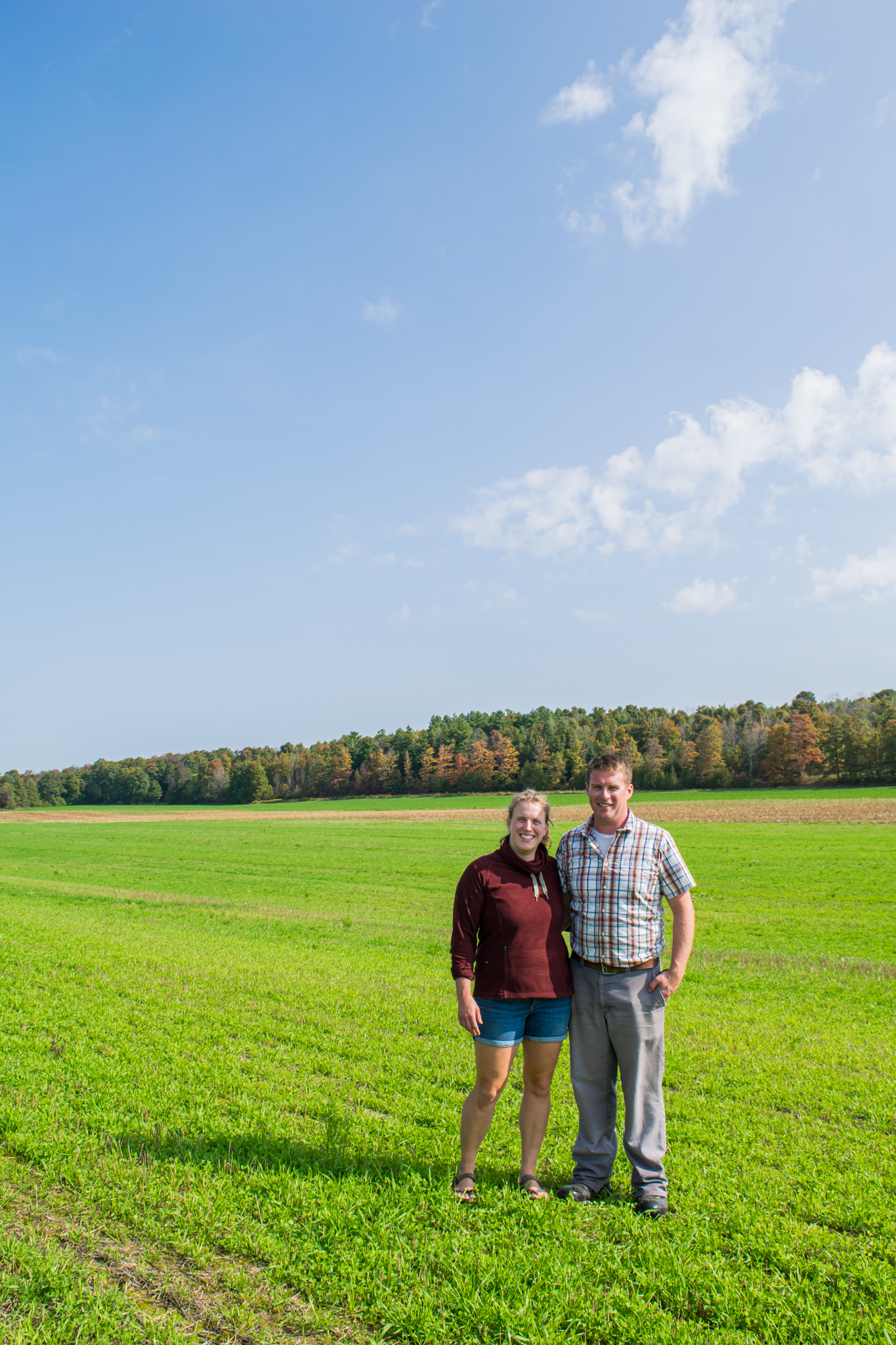 Man and woman standing in farm field