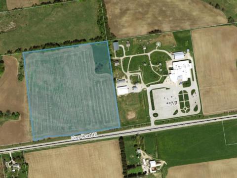 Drone image of a field with additional square graphic to indicate the location of a zoning change.