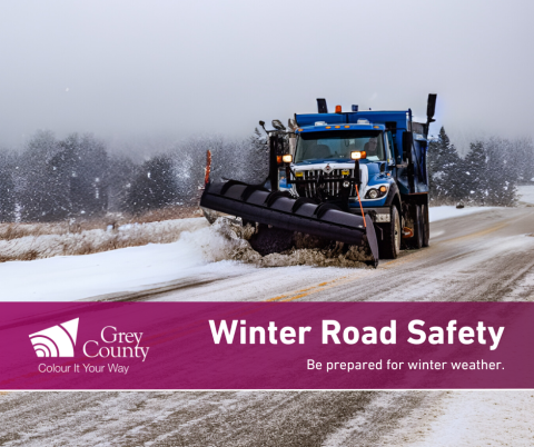 Grey County plow driving on snowy road.