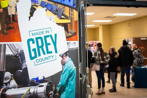 Grey County banner with job fair attendees in background